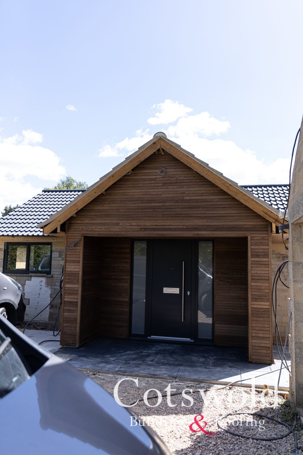 Bungalow clad with soft wood in Fairford designed and constructed by Cotswold Building and Roofing Ltd