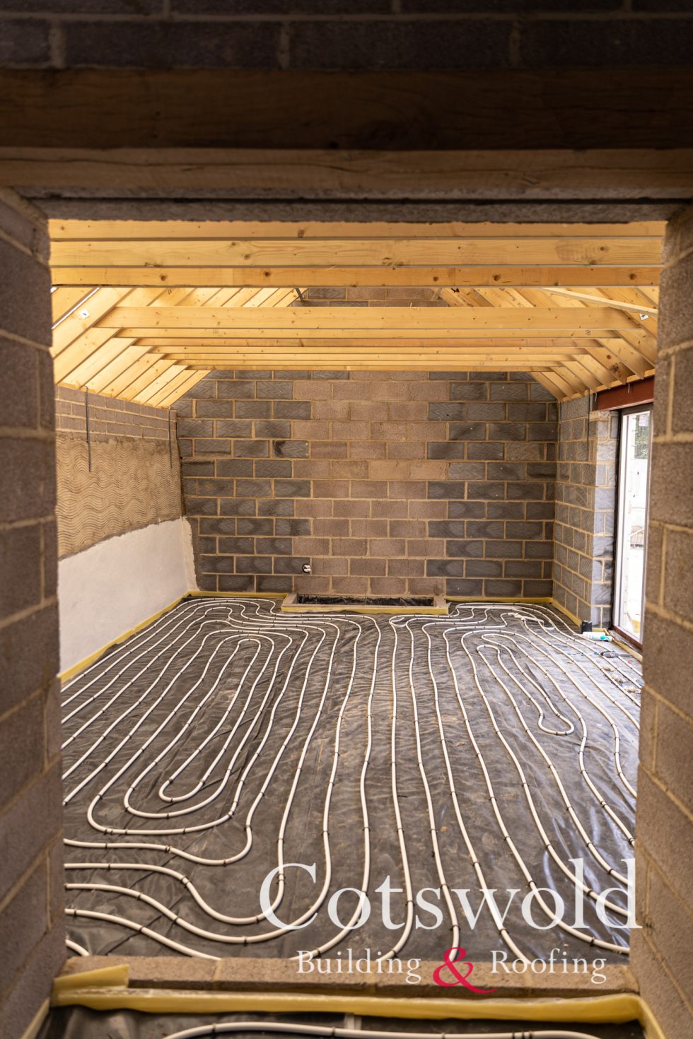 Inside of lounge showing oak truss roof and underfloor heating