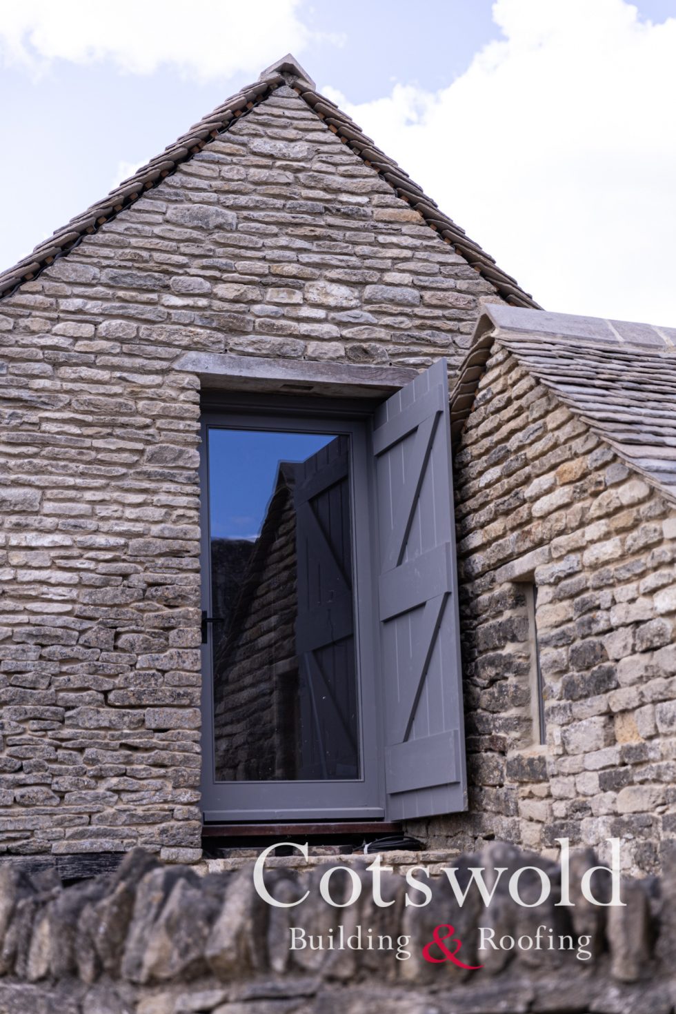 Bedroom barn door onto cotswold stone steps by Cotswold Building and Roofing Ltd