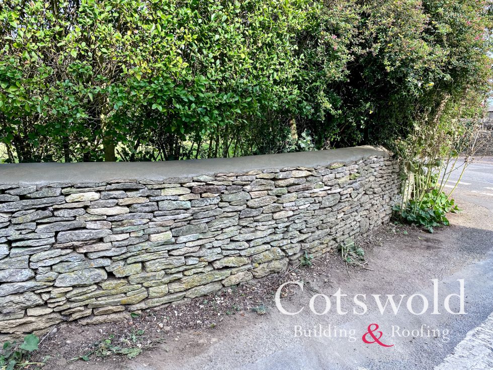 Cotswold stone wall repaired by Cotswold Building and Roofing Ltd